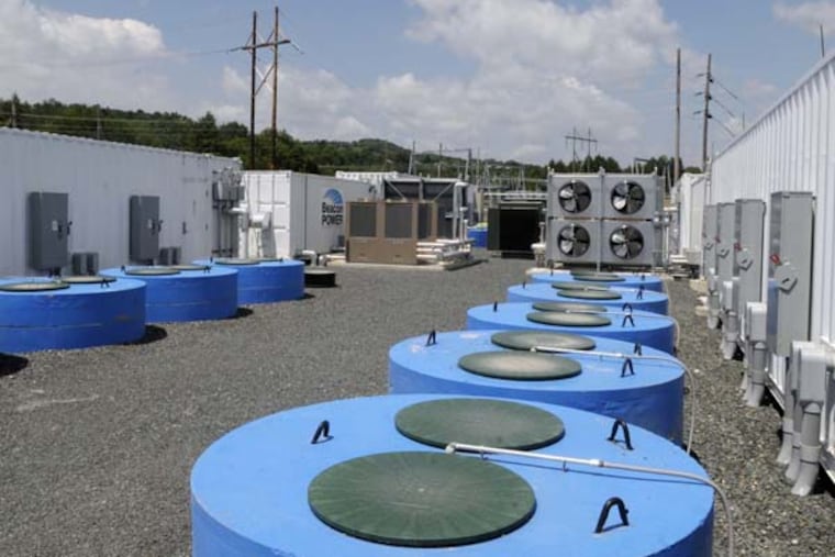 A view of the casings in the ground that house flywheels sealed in a vacuum chamber outside of the control rooms are seen at an event to celebrate the startup of the Beacon Power Flywheel Energy Storage Plant on Tuesday afternoon, July 12, 2011 in Stephentown. The project uses flywheels sealed in vacuum chambers and smart energy matrix modules to send electricity back to the grid. (Paul Buckowski / Albany Times Union)
