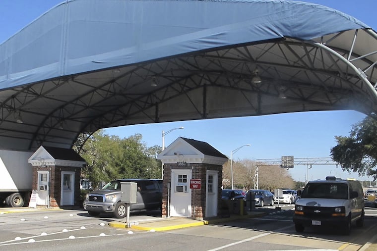 In this Jan. 29, 2016 file photo shows the entrance to the Naval Air Base Station in Pensacola, Fla. The US Navy is confirming that an active shooter and one other person are dead after gunfire at the Naval Air Station in Pensacola. Area hospital representatives tell The Associated Press that at least 11 people were hospitalized. The base remains locked down amid a huge law enforcement response.