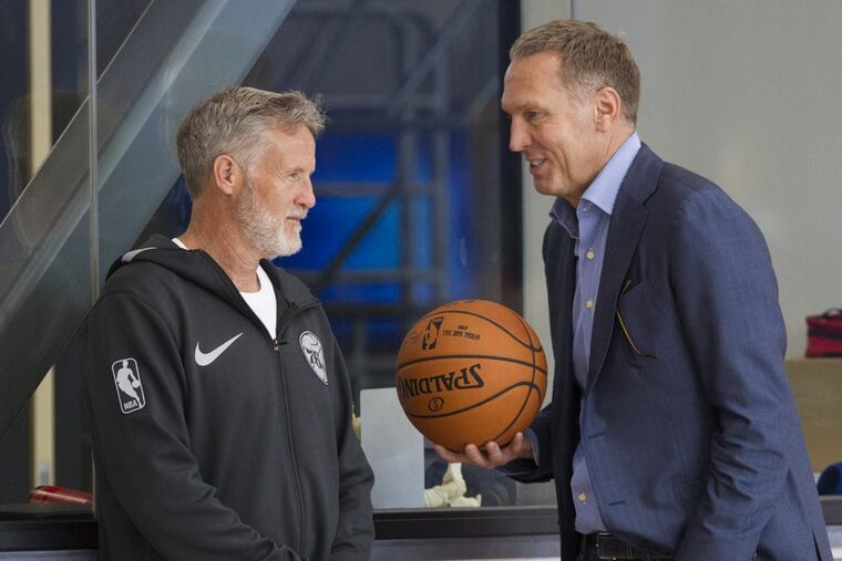 Sixers general manager Bryan Colangelo, right, and coach Brett Brown have reportedly agreed to an extra three years, keeping Brown here through the 2021-22 season.