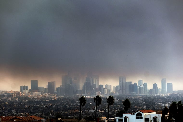 Thick smoke from wildfires shrouds downtown Los Angeles on Wednesday, Jan. 8, 2025.