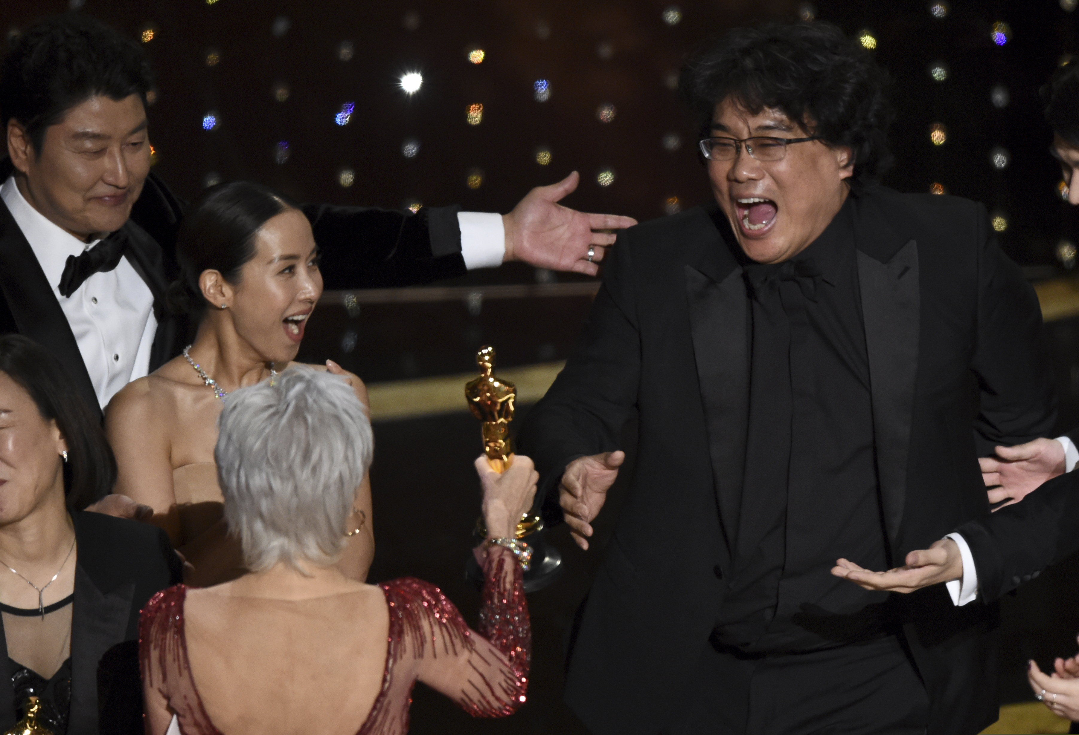 Bong Joon Ho (right) reacts as he is presented with the award for best picture for "Parasite" from presenter Jane Fonda. Looking on from left are Kang-Ho Song and Kwak Sin Ae.