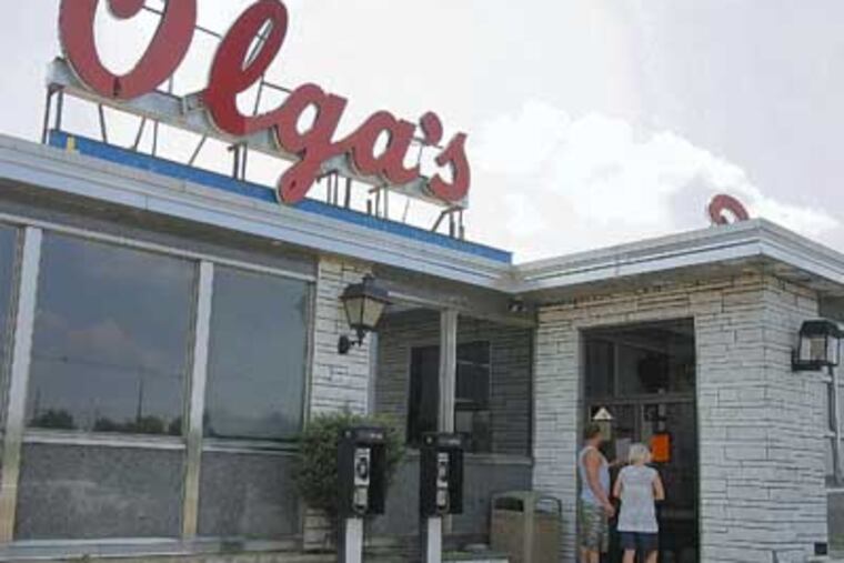Robert Cox,22 and Danielle Haverick, 23 from Long Beach, NJ are reading a Notice of Seizure at the door of the Olga's Diner in Marlton, NJ. They are on the way to Philly and stop by to eat lunch at the Olga's, but it was closed. 07/26/2008 (Akira Suwa / Inquirer ) JOLGA27-A AS EDITORS NOTE - Famous Olga's Diner at Marlton, NJ is closed for violations (non payment of New Jersey State Tax.)