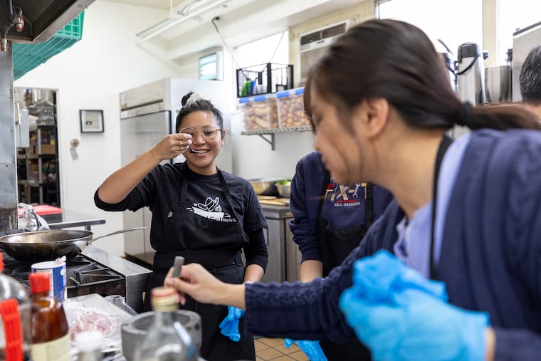 Sabrina Abesamis, 28, of Old City, Pa., tastes the seasoning for the meat in the dan dan noodles with the Asian Food Collective at the Old Pine Community Center in Philadelphia, Pa., on Saturday, March 1, 2025.