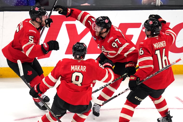 Canada's Connor McDavid (97) celebrates after his overtime winning goal against the United States in Thursday night's 4 Nations Face-Off final.