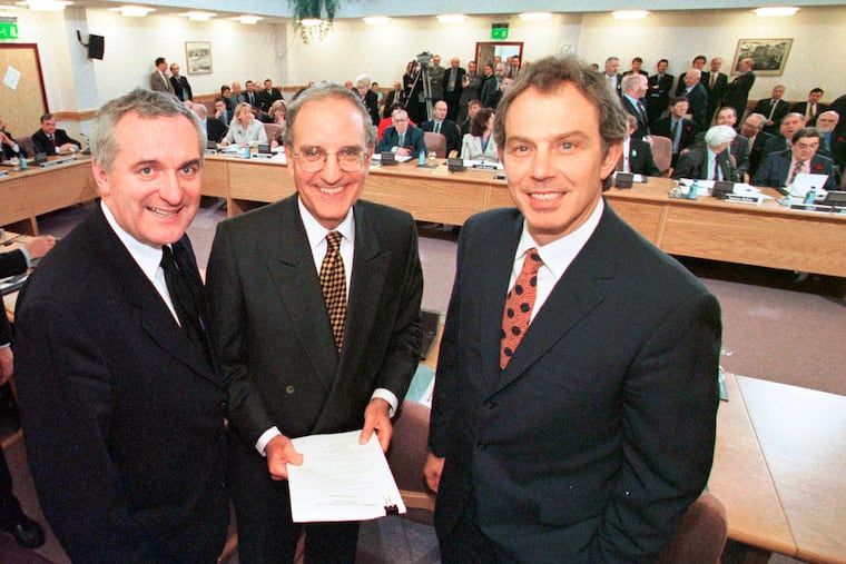 In this April 10, 1998, file photo, from right, British Prime Minister Tony Blair, U.S. Sen. George Mitchell, and Irish Prime Minister Bertie Ahern, pose together after they signed the Good Friday Agreement for peace in Northern Ireland. This set into place a historic power-sharing assembly, devolved from London, and a reduction in the British military’s operations in Northern Ireland.