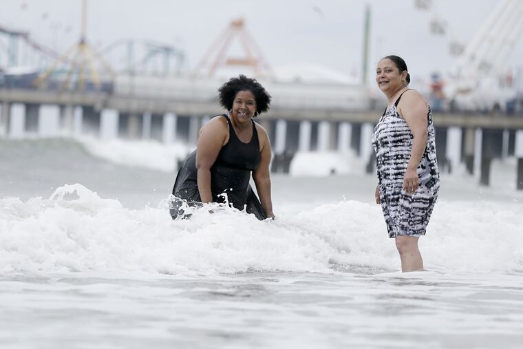 Shannon Bradshaw of Galloway (left) and Kysha Washington of Egg Harbor Township enjoy the ocean at Missouri Avenue in Atlantic City on Sunday.