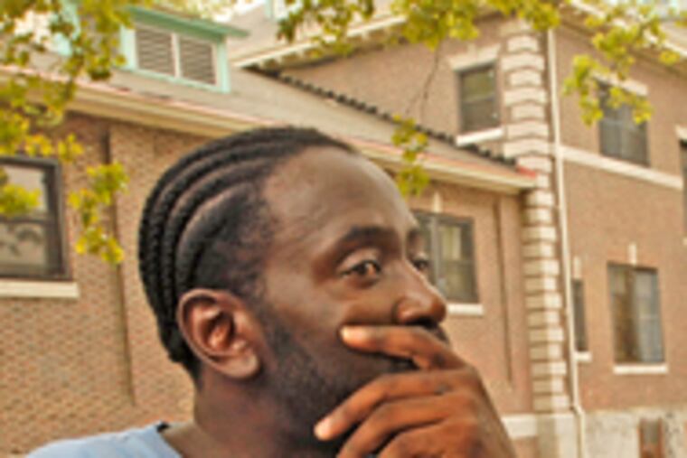 A pensive Darnell Bland sits outside the Athletic Recreation Center at 26th and Jefferson Streets, near where Jamile Collins, 17, was shot to death Wednesday. The burst of violence left three others wounded.