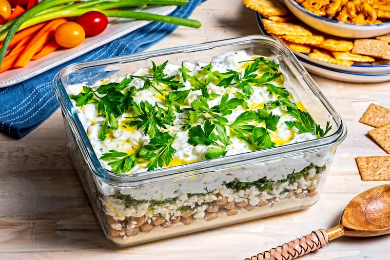 Mediterranean Five-Layer Dip. MUST CREDIT: Scott Suchman; food styling by Lisa Cherkasky/Both for The Washington Post