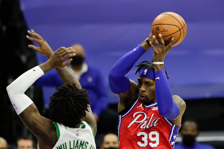 Sixers center Dwight Howard, here grabbing a rebound past Boston Celtics center Robert Williams III, is tied for first in the NBA in rebounds per 36 minutes.