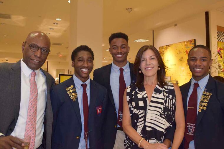 Janine Yass, Boys’ Latin co-founder, with (from left) David Hardy, Keith Boulden, Marqise Dogan, and Nate Morris at the school fund-raiser in King of Prussia. MAGGIE HENRY CORCORAN For the Inquirer