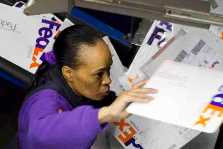 It's sort, sort, sort for workers at the FedEx center in Newark, N.J. The shipper expected to move nearly 16 million packages on its busiest day, up about 13 percent from last year.