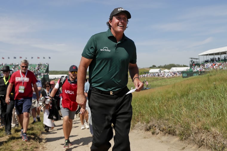 The U.S. Golf Association assessed Phil Mickelson a 2-stroke penalty for hitting a moving ball at the U.S. Open, but did not disqualify him.