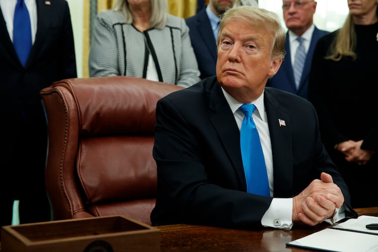 President Donald Trump pauses during a signing event for "Space Policy Directive 4" in the Oval Office of the White House, Tuesday, Feb. 19, 2019, in Washington.