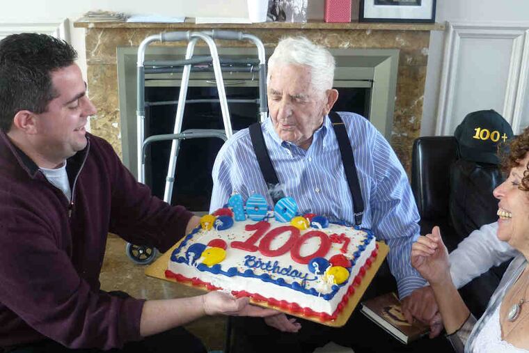 Morris Sorid (above) with grandsonJonathan, grandniece Lidia Wassertheil. Left, the Sorids in '47 at a displaced persons camp in Germany: Regina holding Victor, Morris holding Harvey.