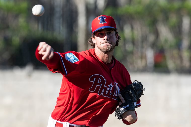 Aaron Nola throws a bullpen session Thursday before holding a news conference to discuss his contract extension with the Phillies.
