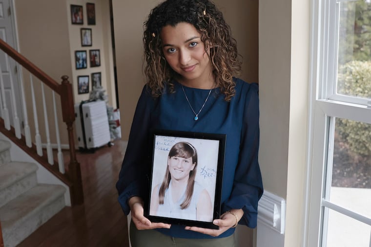 Trinity Jagdeo, 23, holds a 1970s era Pemberton High School photo of Roberta Anne Michels-Hopkins, her grandmother who went missing in 1981.
