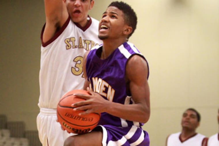 Camden's (2) Tavaris Headen heads up for teh basket followed by St. Anthony's (32) Jordan Campis at the Wildwoods Convention Center December 30, 2012. ( DAVID SWANSON / Staff Photographer )