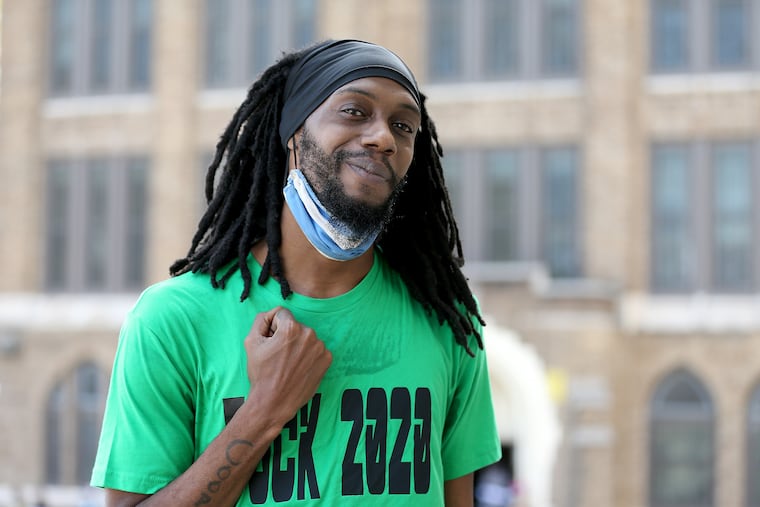 Klinton Cooper stands near the early voting site at Tilden Middle School in Southwest Philadelphia where he cast his ballot Saturday. Video taken of Cooper and other voters dancing while waiting in line to vote went viral over the weekend.