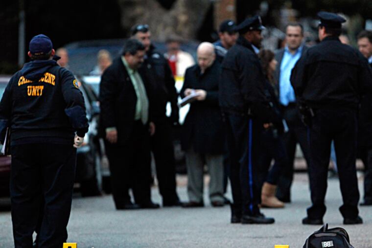 Police gather at the scene, on the 2800 block of South Iseminger Street in South Philadelphia, where Gino DiPietro was gunned down outside his home. DAVID MAIALETTI / Staff Photographer
