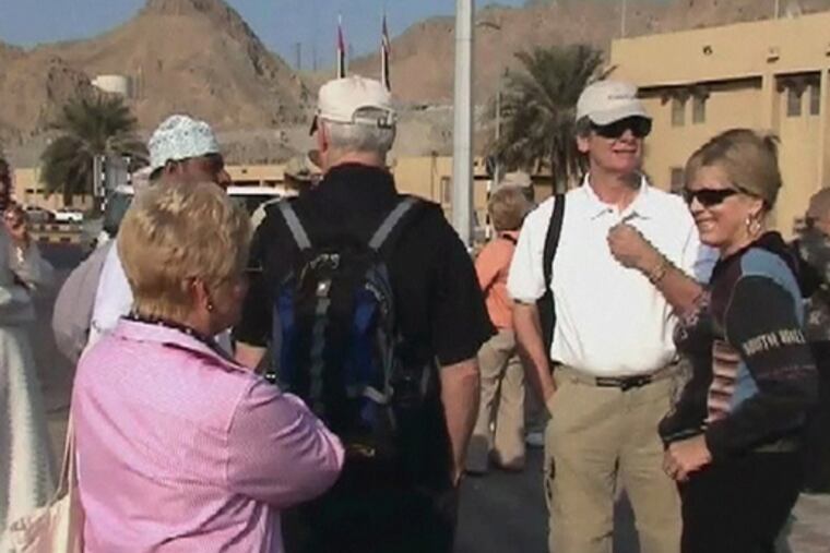 Tourists from the cruise ship M/S Nautica, which outran pirates on Sunday, disembark in Muscat, Oman, yesterday.