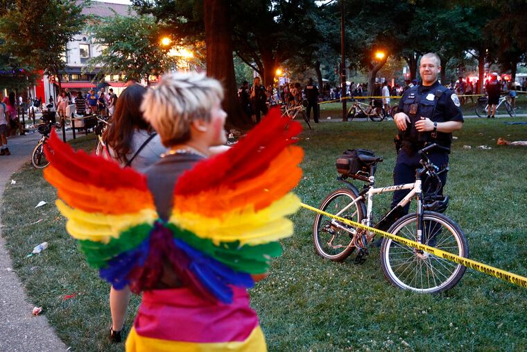 A police officer stands behind crime scene tape, Saturday, June 8, 2019, at Dupont Circle in Washington. Officials in Washington say several people were injured after a panic at the LGBTQ pride parade sent people running through the streets of the nation's capital.