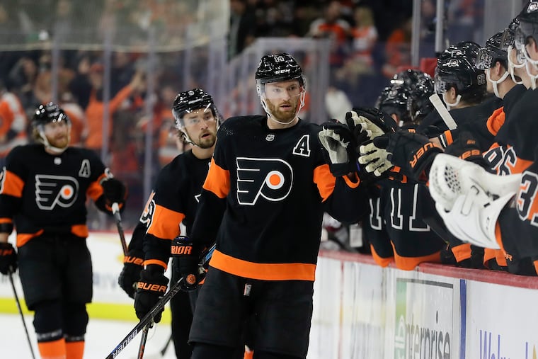 Flyers center Sean Couturier, shown here celebrating a goal last season, injured his shoulder on Friday night.