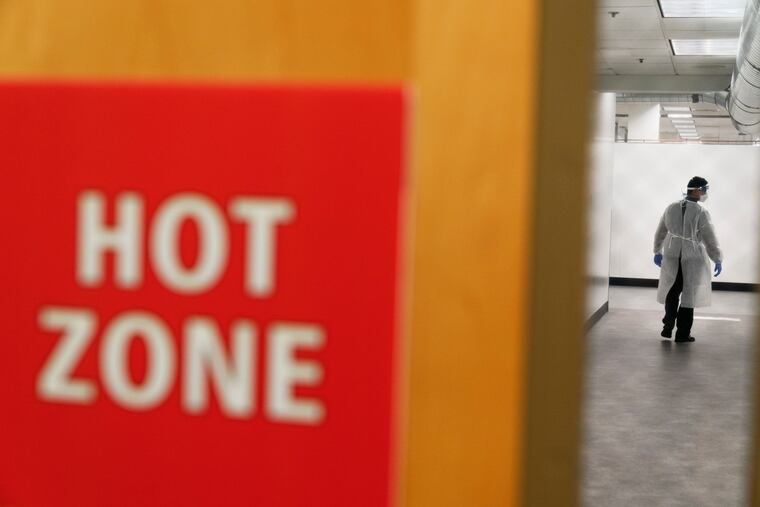 A worker walks through the hallway of a newly opened field hospital operated by Care New England to handle a surge of COVID-19 patients in Cranston, R.I. States faced a deadline on Friday, Dec. 4, 2020, to place orders for the coronavirus vaccine as many reported record infections, hospitalizations and deaths, while hospitals were pushed to the breaking point — with the worst feared yet to come.