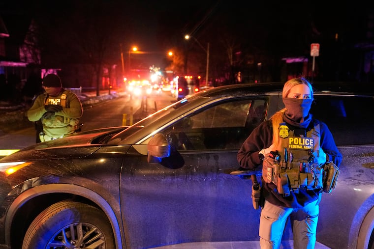 Federal immigration officers at the scene of a reported shooting on Jan. 14, 2026, in Minneapolis.