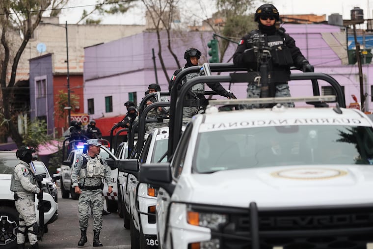 Mexican National Guard troops patrol the area outside of the General Prosecutor's headquarters in Mexico City on Sunday, Feb. 22.
