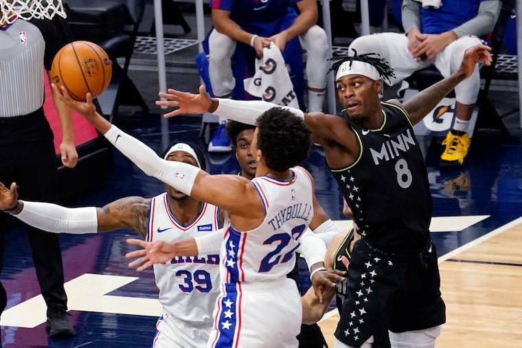 Minnesota's Jarred Vanderbilt (8) tries to block a layup by Matisse Thybulle (22) during the first half.