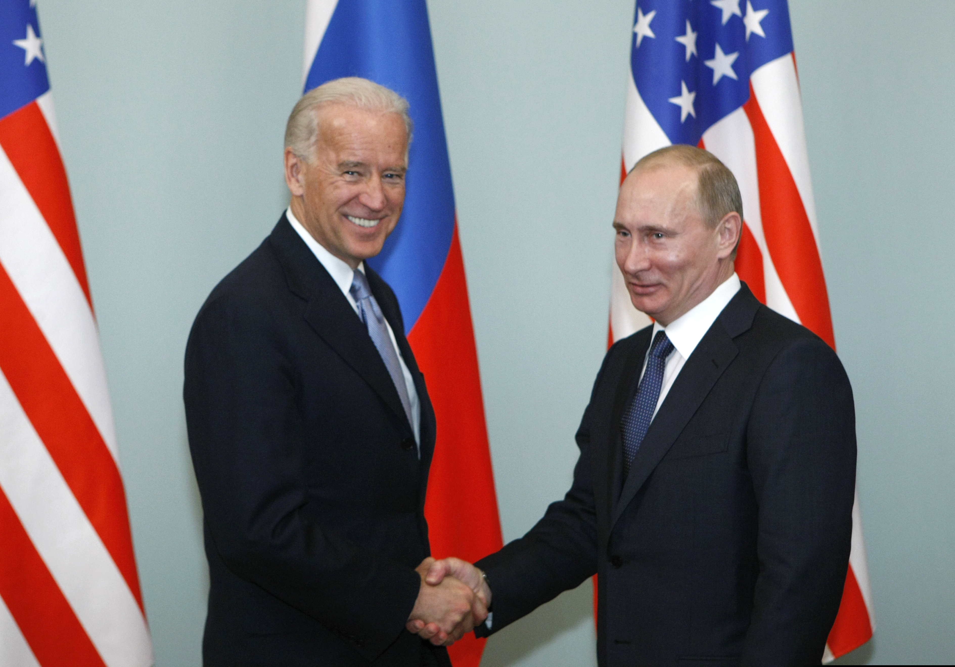 This March 2011 photo shows then-Vice President Joe Biden, left, shaking hands with Russian Prime Minister Vladimir Putin in Moscow.