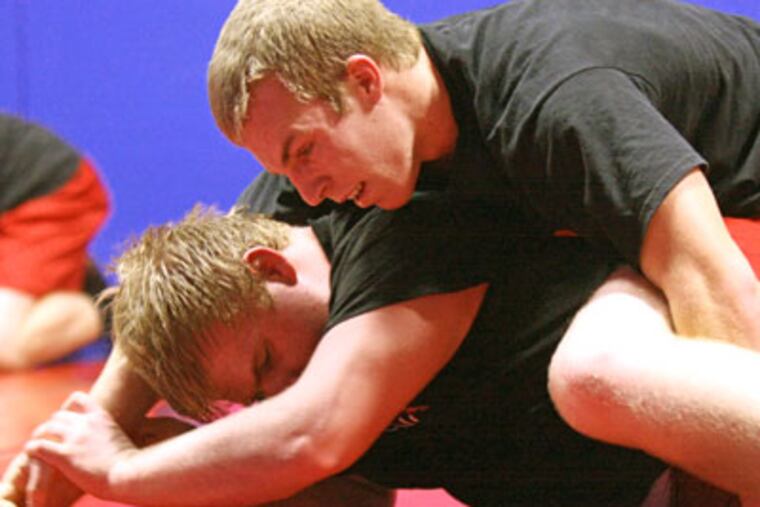 Germantown Academy's Keith Corliss (top) works out with heavyweight teammate Chuck Boddy. (Lou Rabito / Staff)