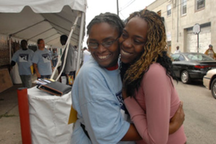 Tiffany Wilder (right) celebrates with Fugitive Safe Surrender volunteer Darleen L. Lewis. A judge lifted a bench warrant for Wilder's arrest for not showing up in court for an auto-theft case.