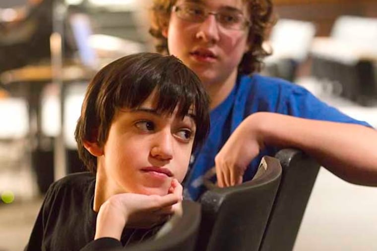 Monica Yant Kinney writes about Ben Harowitz, 13, an 8th grader at Strath Haven middle school in Wallingford, who with some extraordinary help made 30 second public service announcement on bullying which was shown at the school this morning. IN THIS PHOTO Ben Harowitz, left, and his friend Joey Selfrit, who played a part in the film, watch as classmates file into the auditorium to view the PSA on bullying. (Ed Hille / Staff Photographer) Jan 27, 2012 yant29 126889