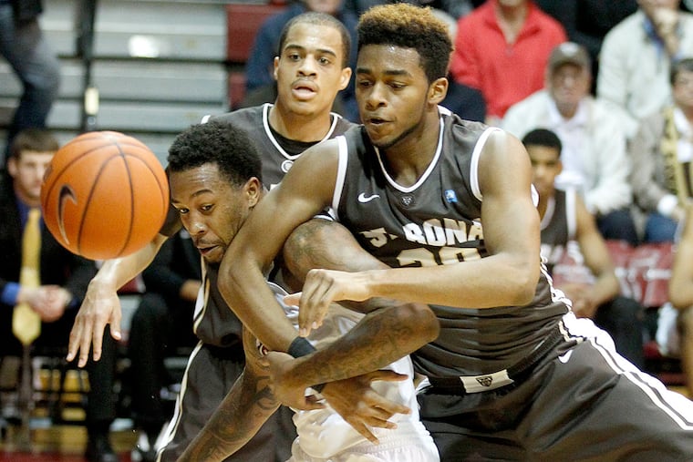 St. Joe's Isaiah Miles (left) battles for a loose ball with St. Bonaventure Derrick Woods.