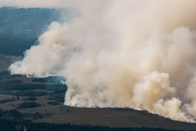 Smoke from a massive wildfire in Belgium's Hohes Venn region is seen from Germany, Sunday, Aug. 16, 2026.