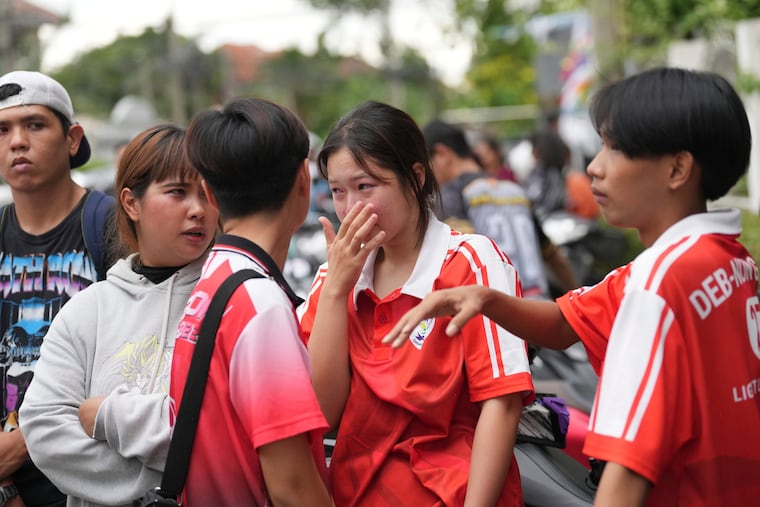 A schoolgirl cries outside her school where deaths and injuries were reported after a shooting in Thailand's Nonthaburi province, Friday, Aug. 7, 2026.