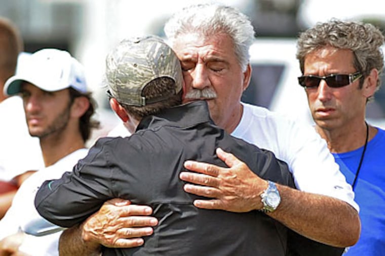 Former director of team security Butch Buchanico hugs Eagles GM Howie Roseman during Sunday's practice. (Photo by Tom Kelly IV)