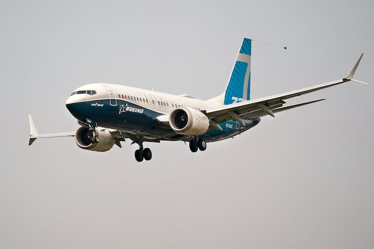 A Boeing 737 Max jet, piloted by Federal Aviation Administration Chief Steve Dickson, prepares to land at Boeing Field following a test flight in Seattle. The FAA is poised to clear the Boeing 737 Max to fly again after grounding the jets for nearly two years due to a pair of disastrous crashes that killed 346 people.