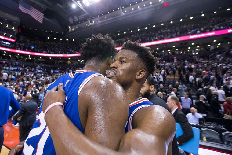 Jimmy Butler, right, of the Sixers is hugged by Joel Embiid after their victory over the Raptors during their NBA playoff game at the Scotiabank Arena in Toronto on April 29, 2019.