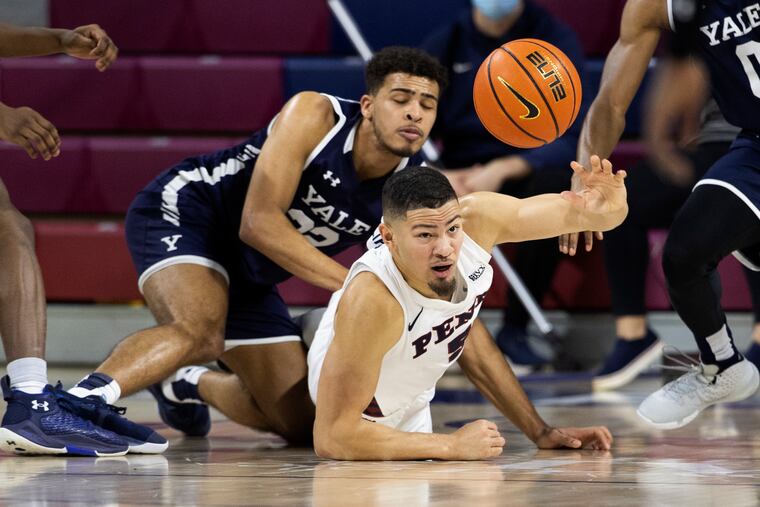 Jelani Williams, right, of Penn comes up with a loose ball in front of Matt Knowling of Yale and pushes it to a teammates late in the game at The Palestra on Jan. 22, 2022.