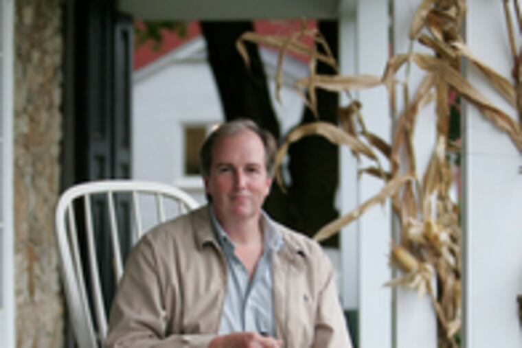 Bill Smith sits with Charlotte, rescued after running away in Maine, on the front porchof the Main Line Animal Rescue in Chester Springs, which he founded and heads.