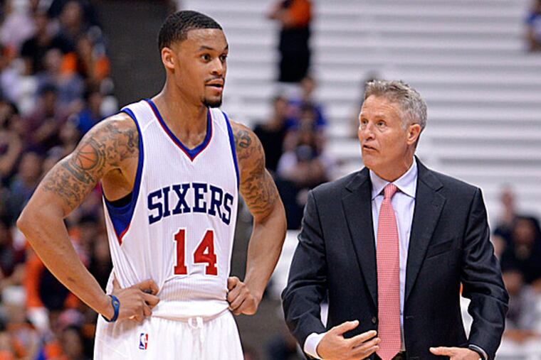 76ers head coach Brett Brown and guard K.J. McDaniels. (Mark Konezny/USA Today Sports)