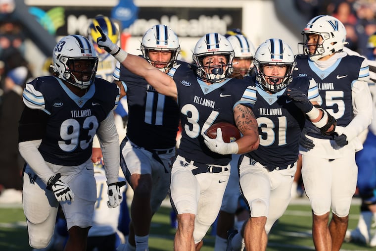 Ethan Potter (center) of Villanova celebrates after recovering a Delaware fumble during the second half of their game on Saturday at Villanova Stadium.