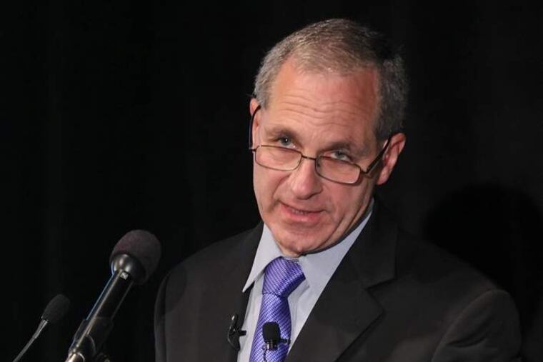 Louis Freeh gestures during his news conference in Philadelphia, on July 12th, 2012, to show how those employees on the lowest level, the janitors, were afraid to report what they saw of the Sandusky Scandal at Penn State. The Freeh Report is being released and Louis Freeh is set to issue his report on who knew what at Penn State about abuse by Jerry Sandusky. (MICHAEL BRYANT / Staff Photographer )