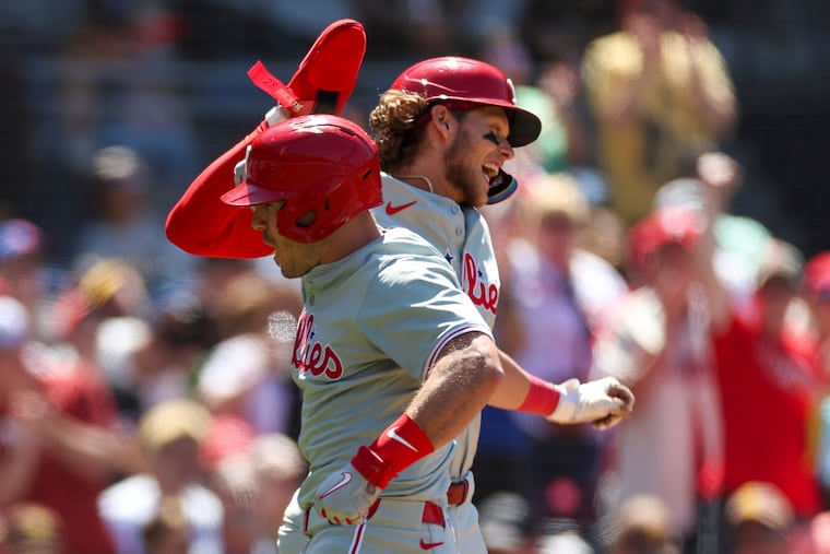 J.T. Realmuto (left) celebrates his two-run home run for the Phillies against the Padres with Alec Bohm.