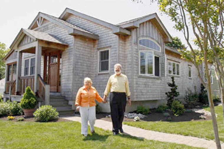 Dottie Knapp, outside their new cottage with husband Mal, says, "By keeping it small, it meant we could put money into things that made a difference" - like the real cedar shingles on the exterior. (Elizabeth Robertson / Staff photographer)