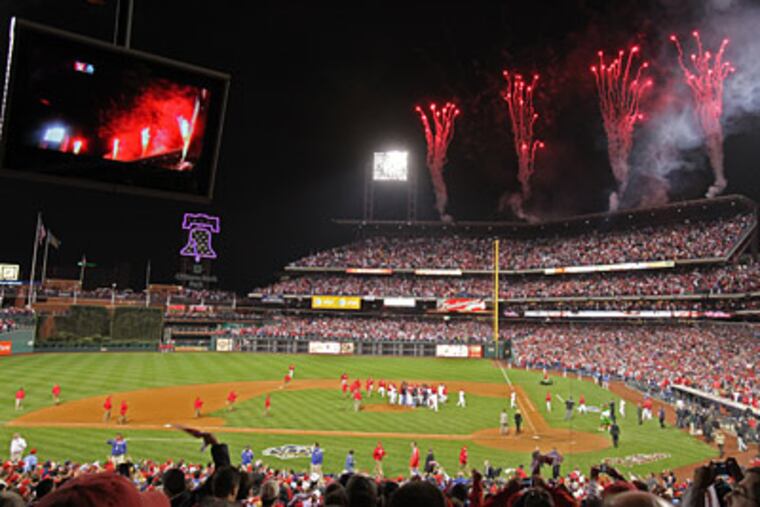 Phillies fans celebrate Roy Halladay's no-hitter against the Reds in Game 1 of the NLDS. (David M Warren / Staff Photographer)