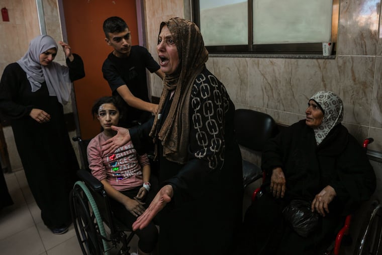 At al-Aqsa hospital in Deir el-Balah, central Gaza Strip, a Palestinian woman reacts next to the wounded during an Israeli airstrike on Sunday, Oct. 15, 2023.