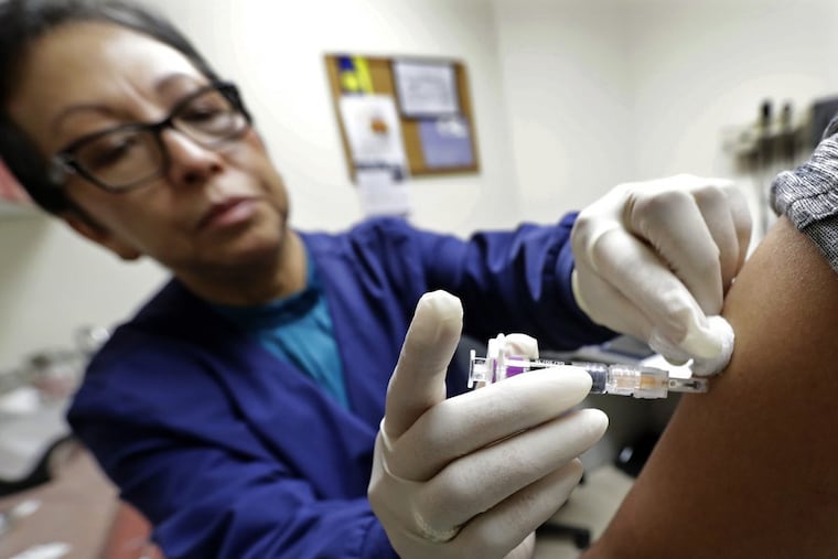 Ana Martinez, a medical assistant at the Sea Mar Community Health Center, gives a patient a flu shot, Thursday, Jan. 11, 2018 in Seattle.
